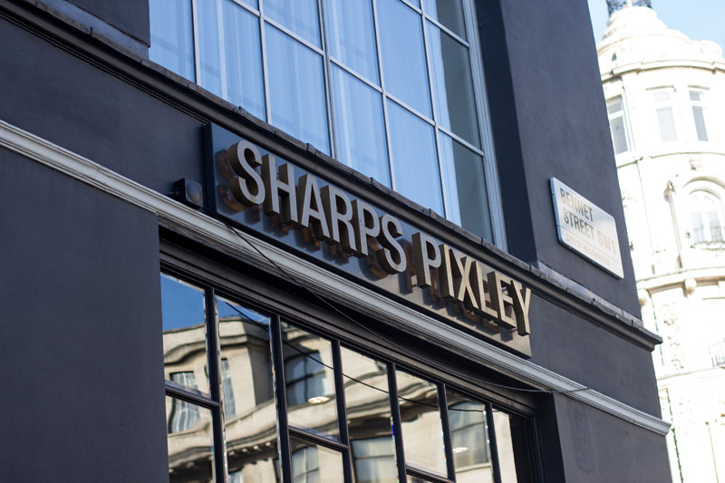 Built Up Patinated Brass Fascia Signage for Sharps Pixley