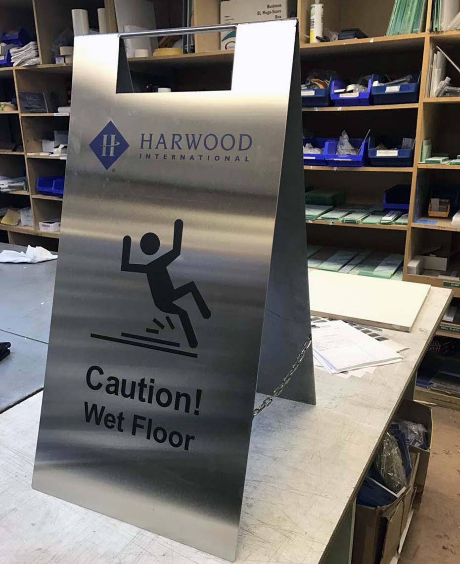 Front View of Bespoke Stainless Steel Wet Floor Sign for Harwood International